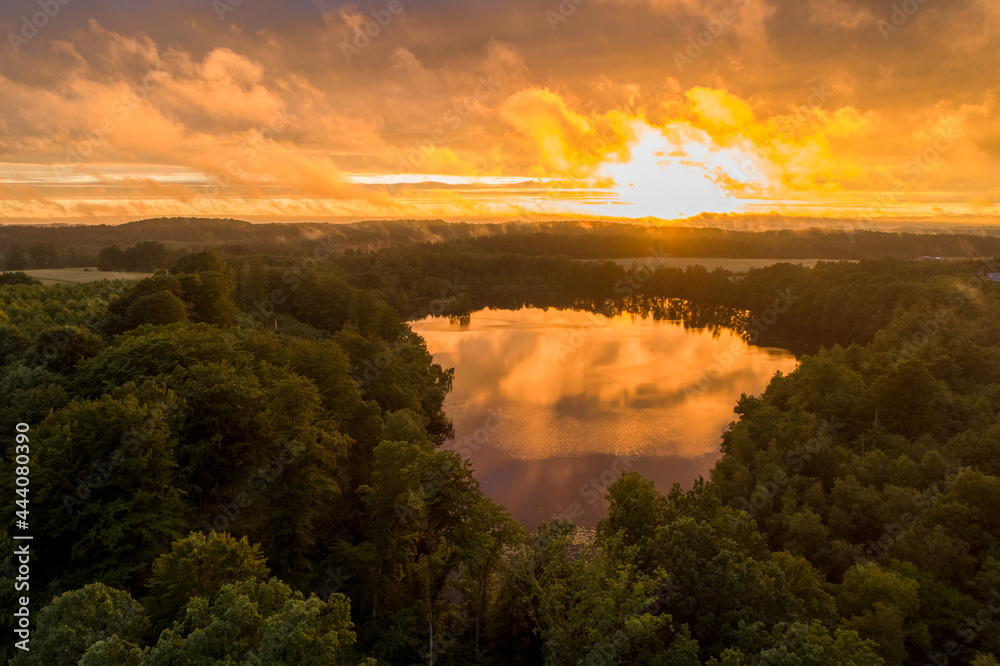 Fields, meadows and forests with a beautiful sunset. Polish countryside in amazing nature conditions and beautiful light. Orange sun and cloudy forest. Fields, meadows and forests with a beautiful sunset. Polish countryside in amazing nature conditions and beautiful light. Orange sun and cloudy forest.