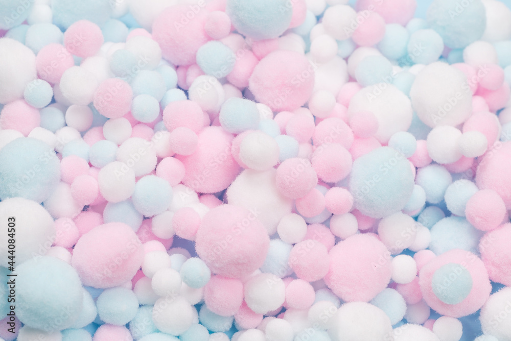 White, pink and blue soft pompons as a background. White, pink and blue soft pompons as a background.