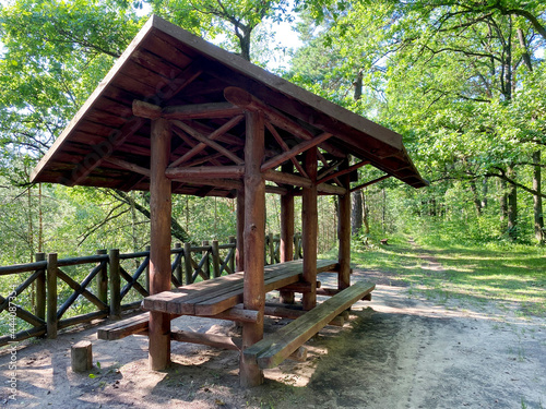 Wooden gazebo for vacationers in the forest