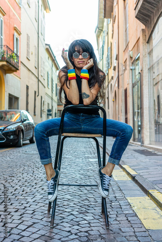 hsipanic latino woman in the street wearing pride lgbt bands photo