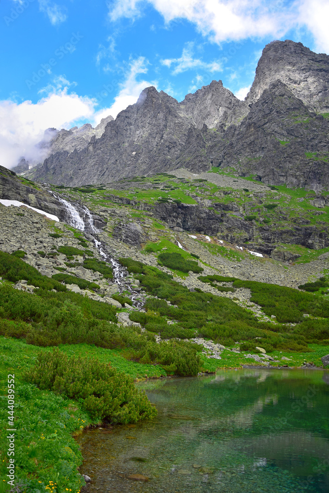 Landscape of the High Tatra mountains. Lake Velicke pleso, waterfall Velicky vodopad and mountains. Slovakia.