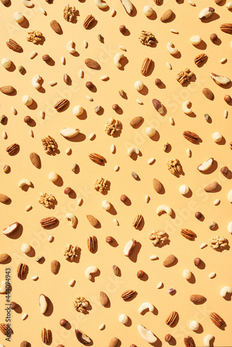 Background of various tasty nuts on beige table