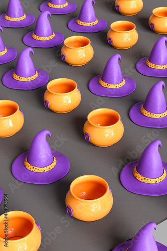 pattern of orange cauldrons and purple witch hat on dark grey background photo