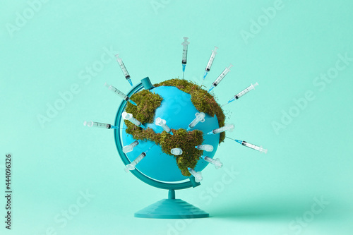 Earth globe with moss and syringes photo