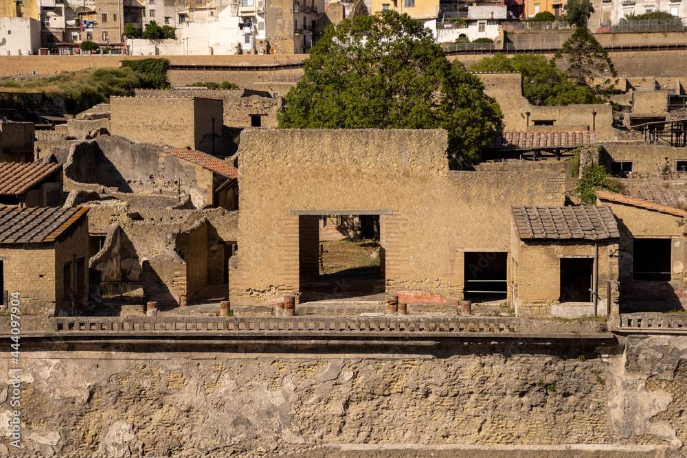 Obraz premium Ruins, streets and buildings of ancient roman town Ercolano - Herculaneum, destroyed by the eruption of the Mount Vesuvius or Vesuvio volcano. Historical park of Ercolano, Italy