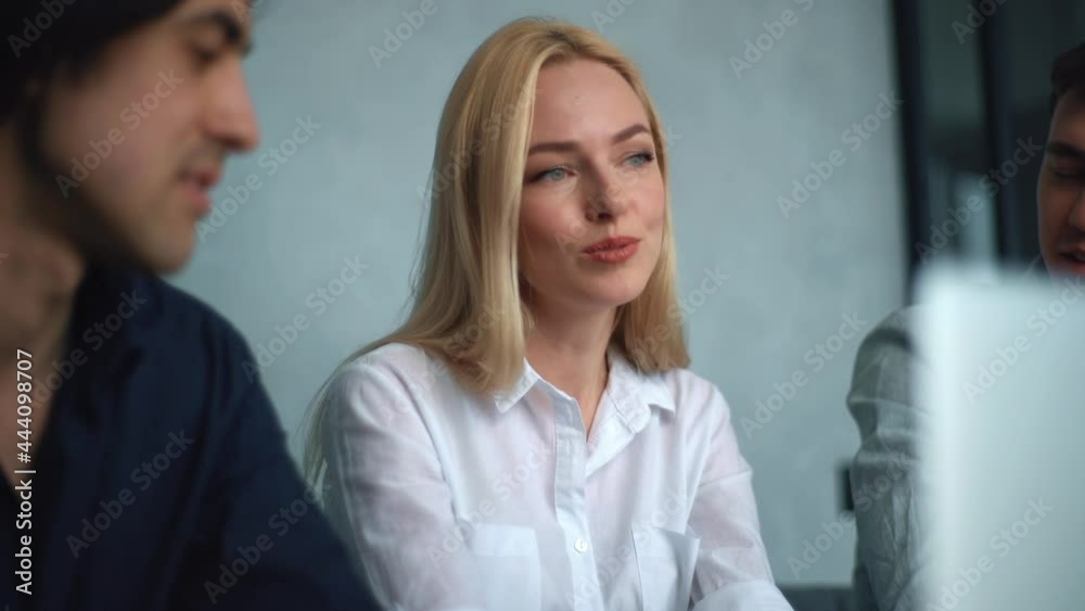 Close-up face of young cheerful business team young people brainstorm on project during corporate meeting. Tracking shot of colleagues listening attractive blonde businesswoman sharing new ideas. Close-up face of young cheerful business team young people brainstorm on project during corporate meeting. Tracking shot of colleagues listening attractive blonde businesswoman sharing new ideas.