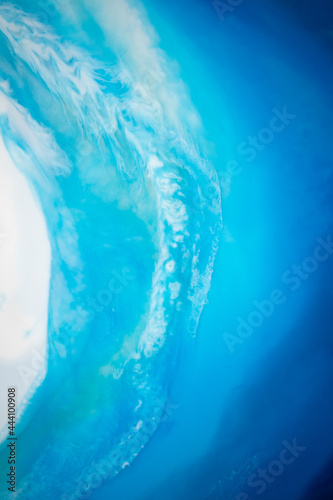 Part of original resin art epoxy resin painting. High quality details. Marble texture. Fluid art for modern banners, ethereal graphic design. Abstract ethereal bronze, blue and white swirl.