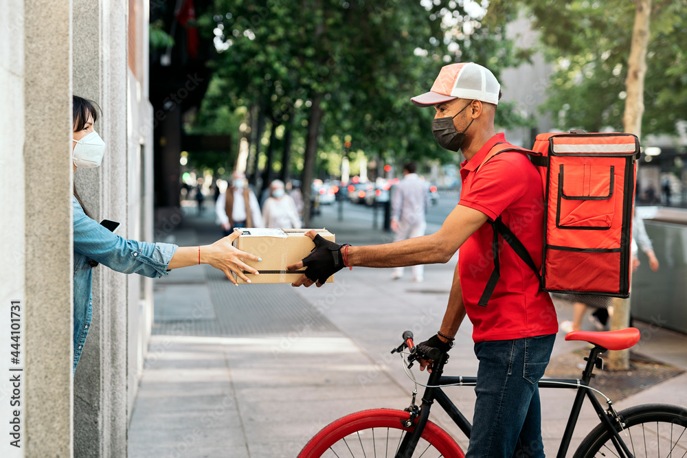 © Santi Nuñez/Stocksy - Woman Receiving a Package