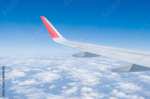 Airplane wing, Clouds and blue sky has seen through the window of an aircraft view