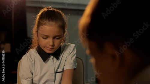 Intelligent girl playing chess with a young boy photo