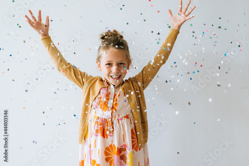 Blond girl trowing confetti around