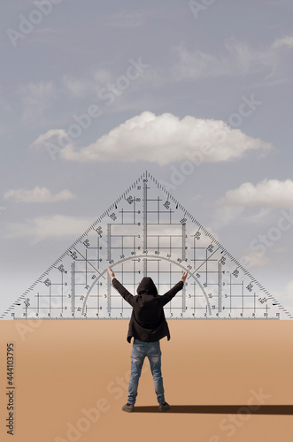 A man with raised arms stands in front of a giant protractor
