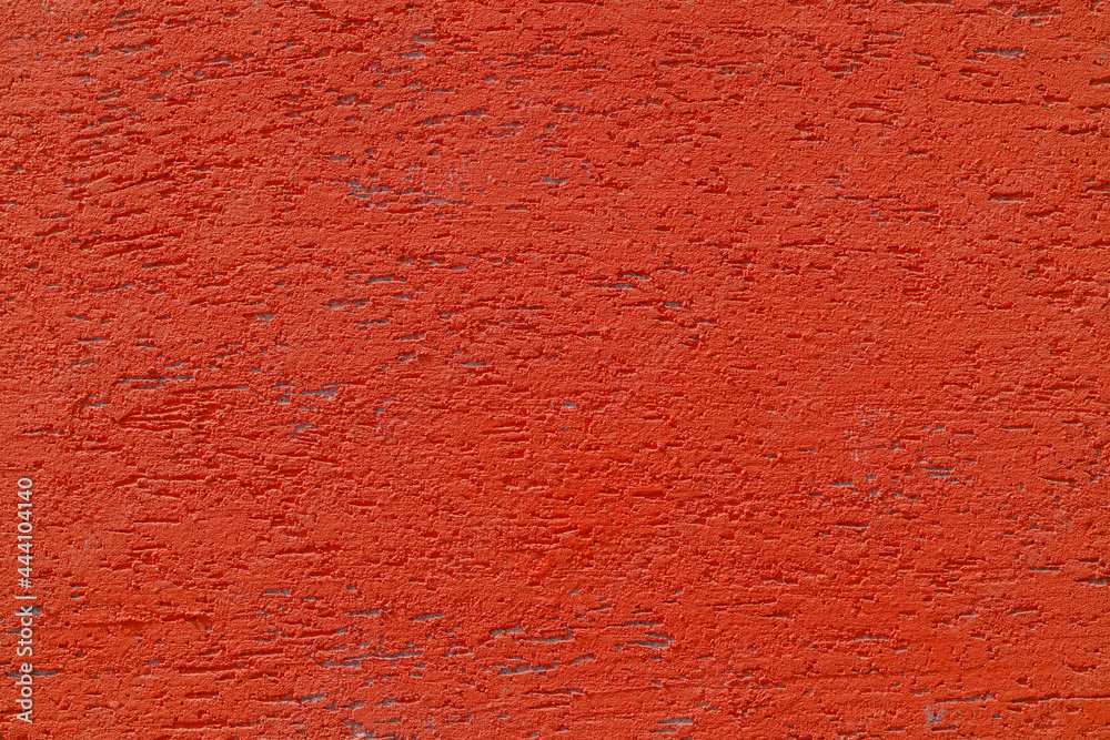Red plaster wall of a building. Rough surface texture. Red plaster wall of a building. Rough surface texture.