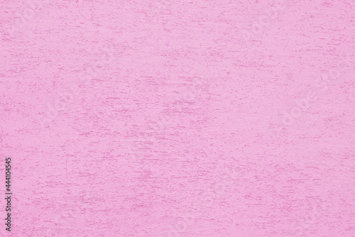Pink plaster wall of a building. Rough surface texture.