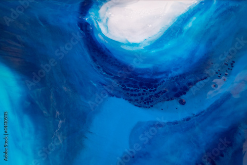 Part of original resin art epoxy resin painting. High quality details. Marble texture. Fluid art for modern banners, ethereal graphic design. Abstract ethereal bronze, blue and white swirl.