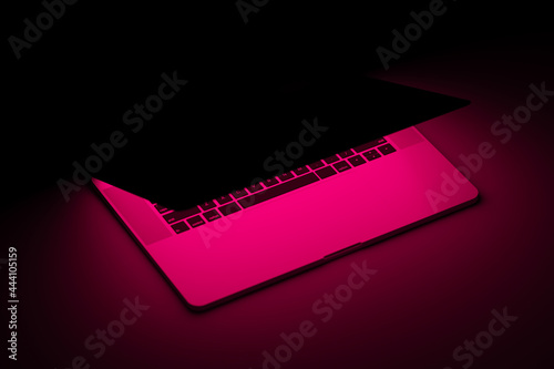 Laptop with fuchsia neon light illuminated screen ready to play
