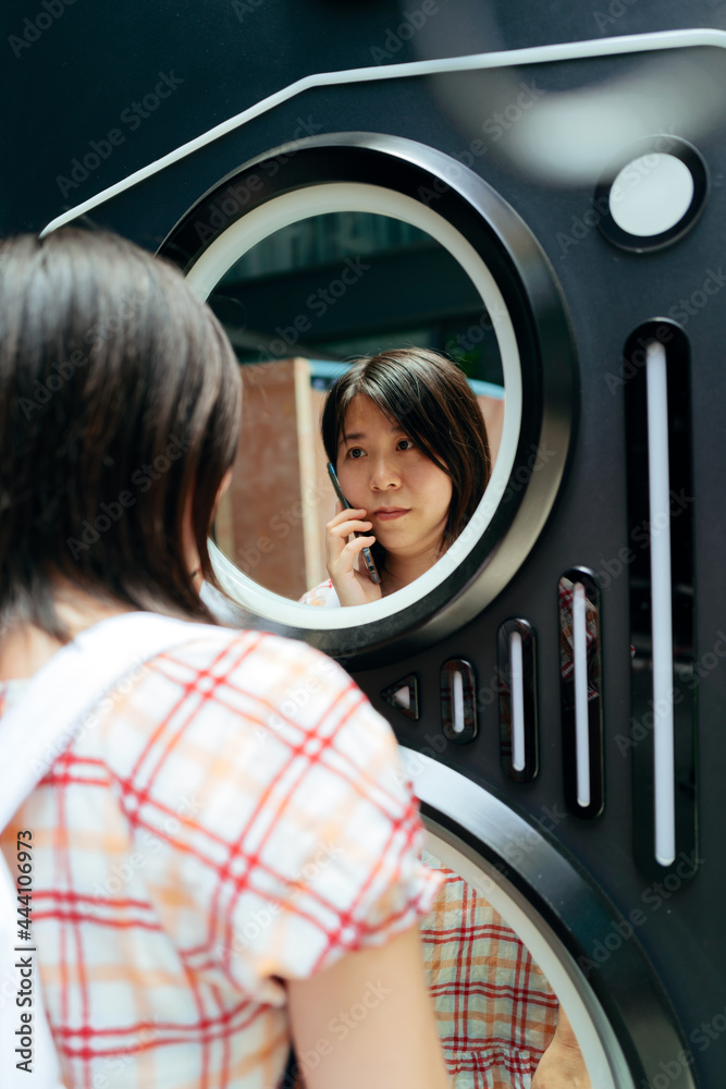 Asian women using cell phone Asian women using cell phone
