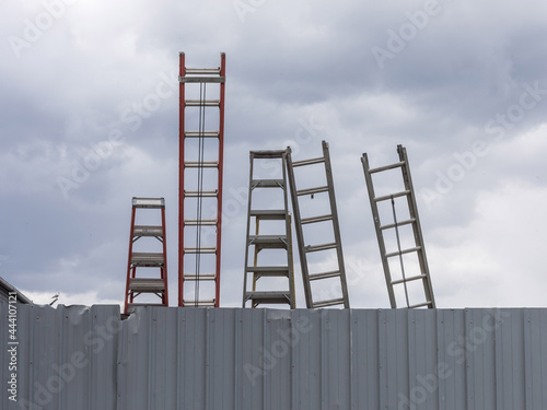 Ladders against a fence