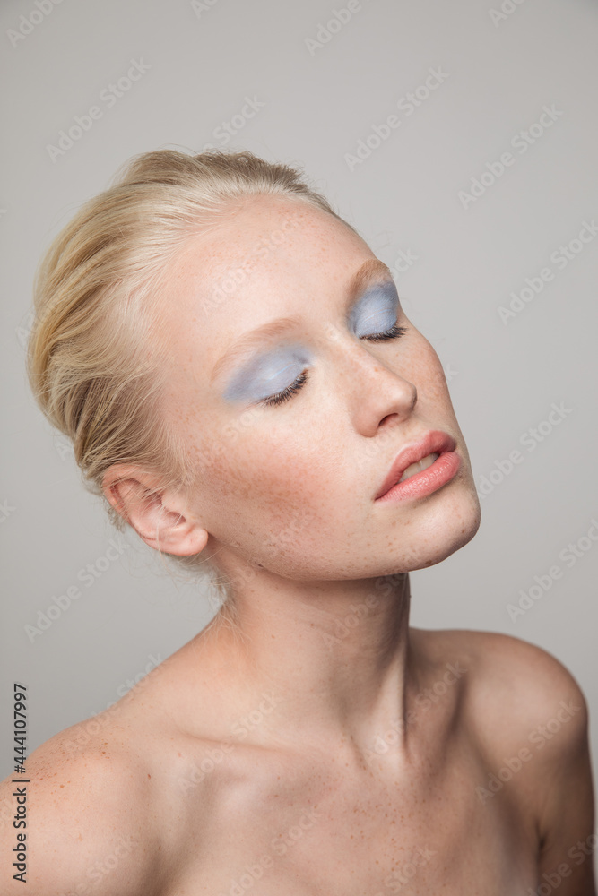 Young freckled model with blue eyeshadows Young freckled model with blue eyeshadows
