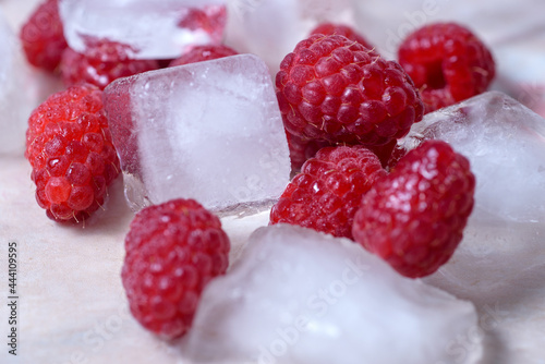 Fresh raspberries in ice  close-up