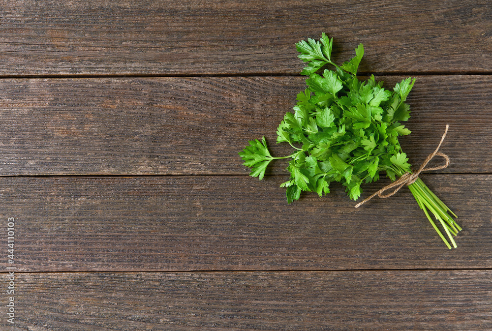 bunch of fresh parsley on wooden table, top view. Copy space for text. bunch of fresh parsley on wooden table, top view. Copy space for text.