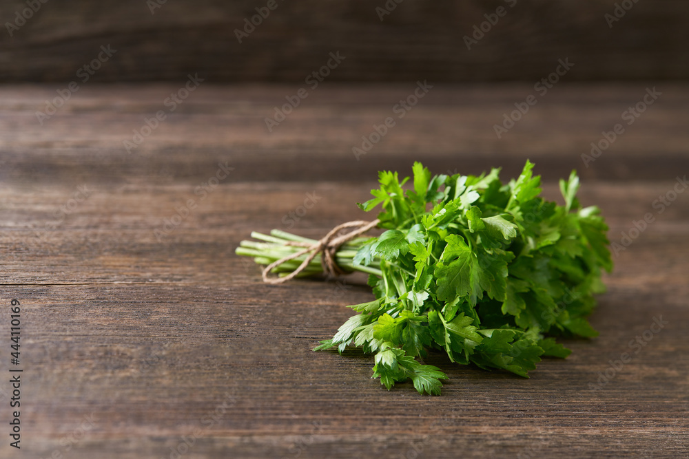 bunch of fresh parsley on wooden table, selective focus. bunch of fresh parsley on wooden table, selective focus.
