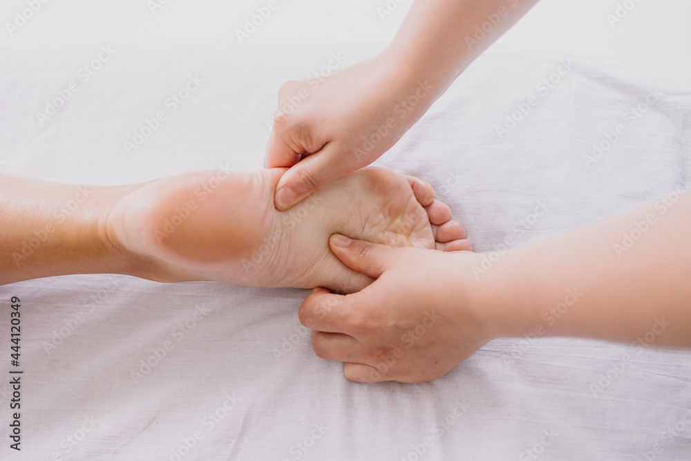 Foot massage close-up. Spa salon self-care relax. Kneading the feet. Pleasant pleasures. The masseur is working. Treating fatigue and leg pain. Health care acupuncture. massaging Heel fingers foot Foot massage close-up. Spa salon self-care relax. Kneading the feet. Pleasant pleasures. The masseur is working. Treating fatigue and leg pain. Health care acupuncture. massaging Heel fingers foot
