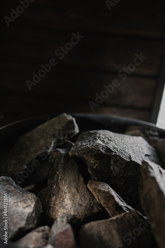 Hot stones in the sauna close-up. Heater heat generator. beautiful luxury equipment. Black stone texture
