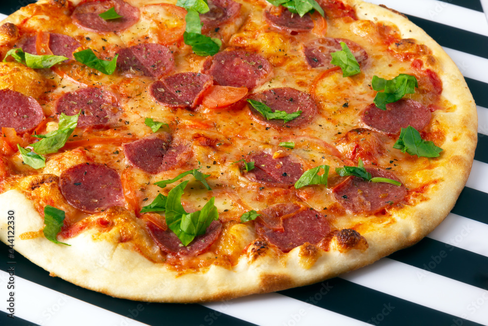 Pepperoni pizza with salami, mozzarella and tomatoes. Pepperoni pizza with salami, mozzarella and tomatoes.
