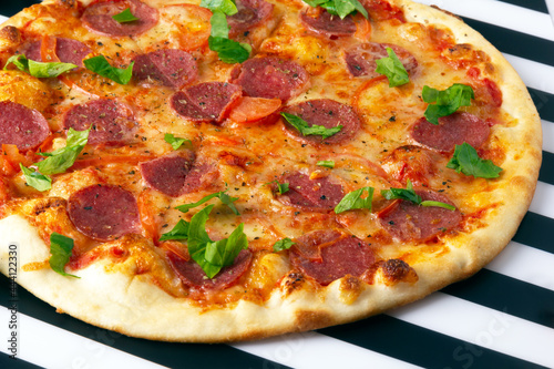 Pepperoni pizza with salami, mozzarella and tomatoes.