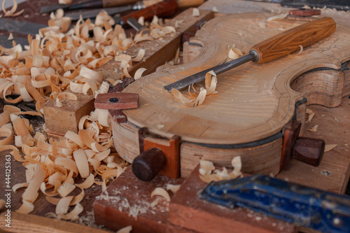 Luthier workshop where violins are building with different tools to work on wood