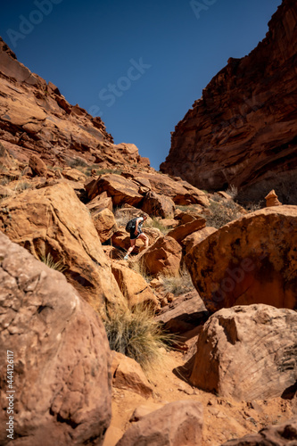 Woman Hiking Over Large Boulders in Upheaval Crater