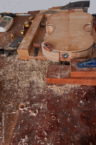 Luthier workshop where violins are building with different tools to work on wood