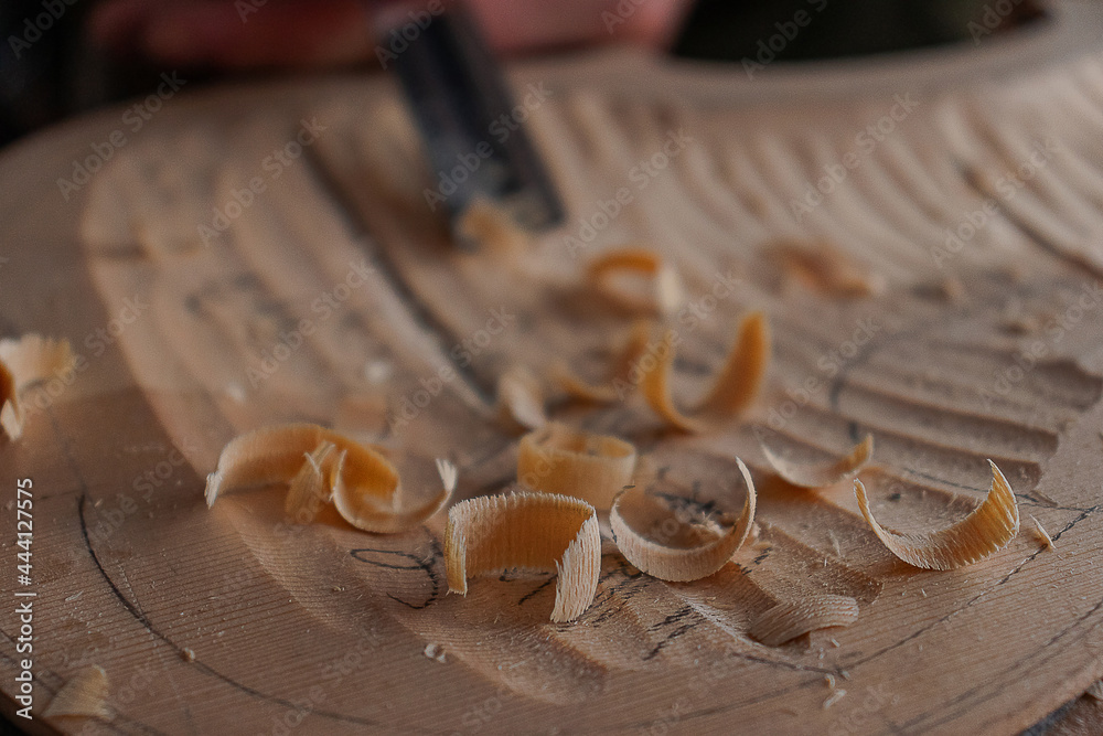 Luthier's hands using gouge to work the wood and make a violin Stock ...