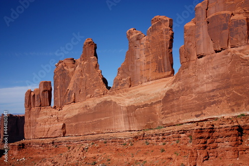 the incredible red rock formations of park avenue on a sunny day in arches national park, near moab, utah