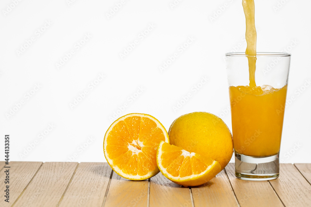 Glass with orange juice on table on white background Glass with orange juice on table on white background