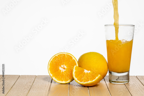 Fototapeta Naklejka Na Ścianę i Meble -  Glass with orange juice on table on white background