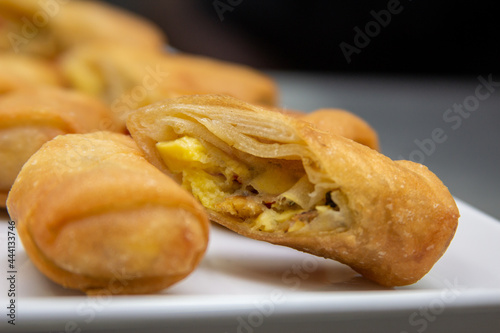 Ackee & Saltfish Spring Roll On White Plate With Black Background