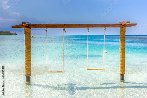 Swing on the beach in the water