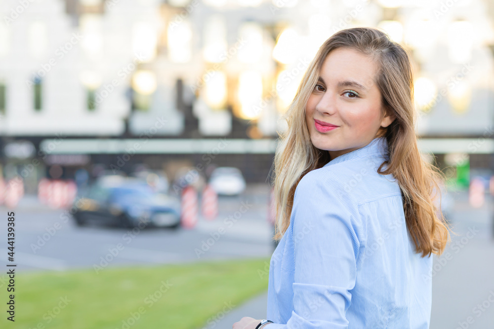 closeup portrait beautiful lady looking at camera over her shoulder. happy attractive girl go to car in parking. young woman with smile ready to travel on automobile. female buying car closeup portrait beautiful lady looking at camera over her shoulder. happy attractive girl go to car in parking. young woman with smile ready to travel on automobile. female buying car