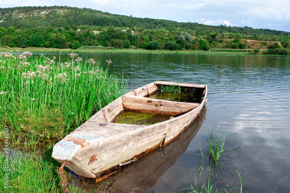 Sunken wooden fisherman boat . Old wooden barque . Picturesque river nature Sunken wooden fisherman boat . Old wooden barque . Picturesque river nature