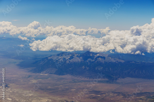 The view from the plane of fluffy clouds in mountains from an airplane, Arizona USA