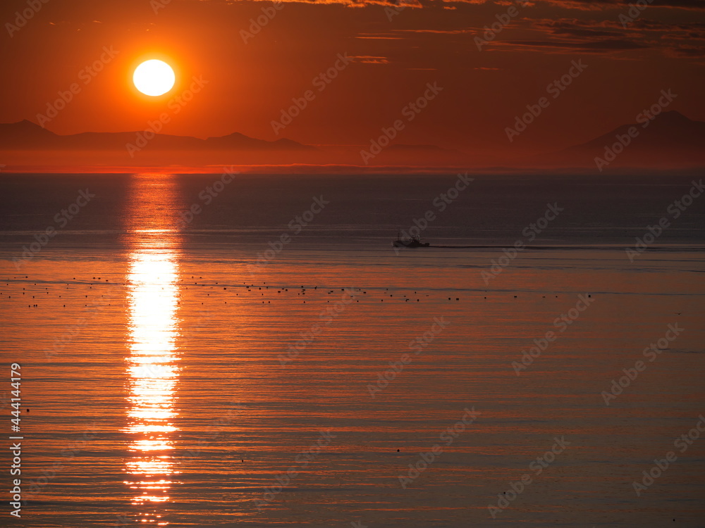 Hokkaido,Japan - June 22, 2021: Kunashiri island and the rising sun viewed from Rausu,Nemuro strait, Hokkaido, Japan
Hokkaido,Japan - June 22, 2021: Kunashiri island and the rising sun viewed from Rausu,Nemuro strait, Hokkaido, Japan