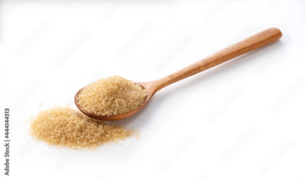 Wooden spoon and brown sugar placed on a white background. Wooden spoon and brown sugar placed on a white background.