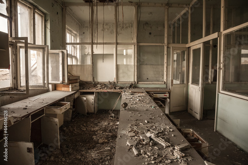 Interior of an abandoned office building, in a dirty and damaged room, with an old desk remaining after the closure and the bankruptcy of the business. .... photo