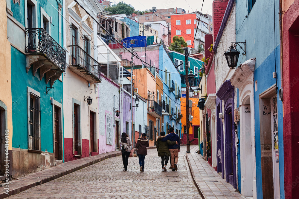 groups of friends walking up a colorful street of Guanajuato 