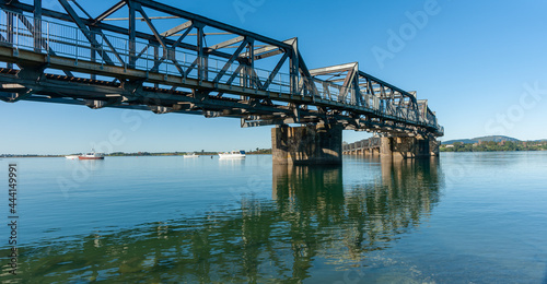 Curving lines of historic steel truss railway bridge