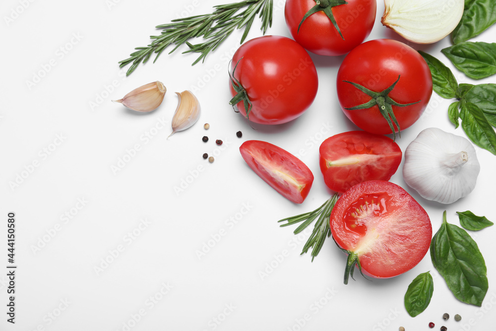Composition with fresh basil leaves and tomatoes on white background, flat lay Composition with fresh basil leaves and tomatoes on white background, flat lay