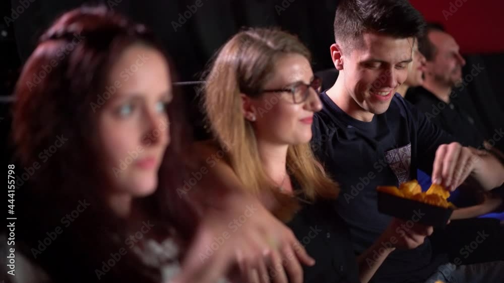 Young people in a movie theater enjoying a film - people photography Young people in a movie theater enjoying a film - people photography