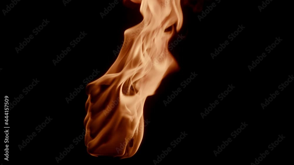 Burning fire flame torch with isolated black background - close up shot